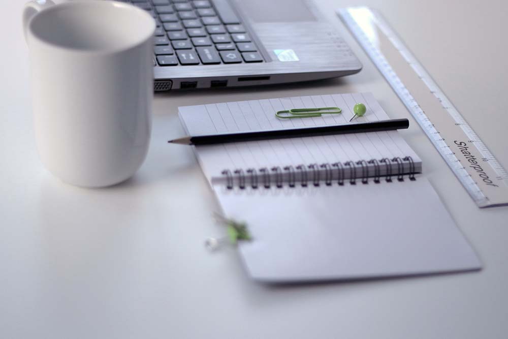 Desk with computer notebook and pencil