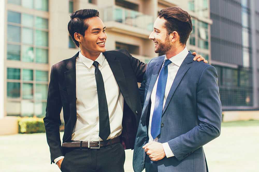 Two businessmen with arms around each other