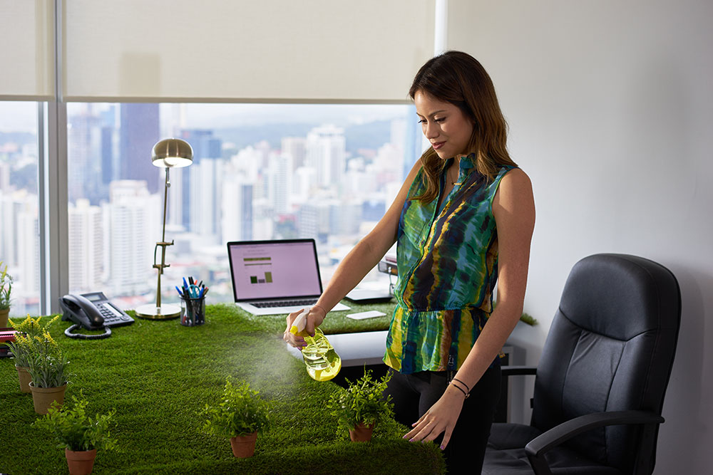 women watering plants at her desk