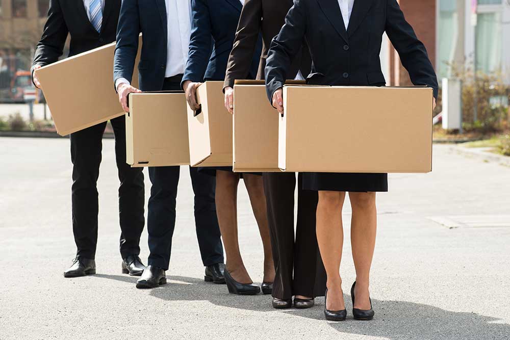 Business people holding boxes - protectionism