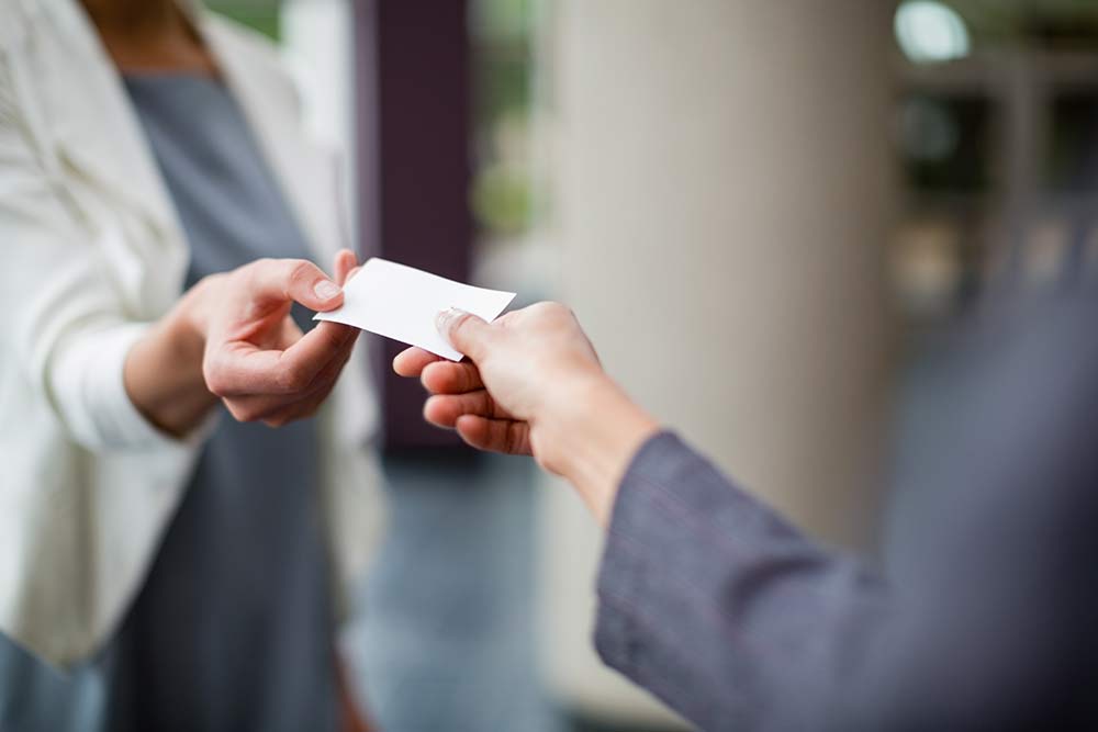 Handing a colleague a business card