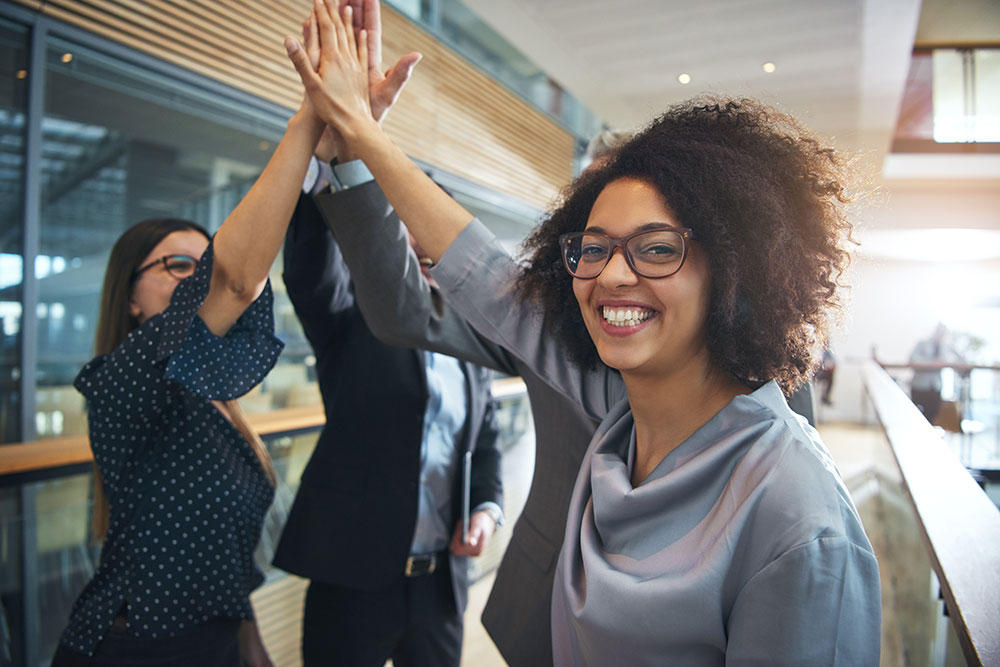 Group of business people high fiving