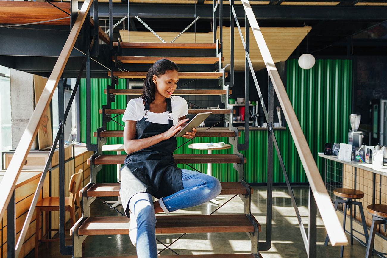 Small business owner reviewing files on tablet