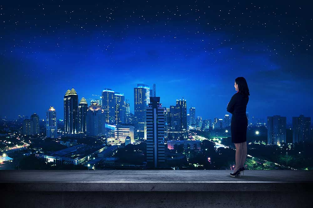 Business person looking out over cityscape