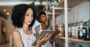 small business woman checking inventory on tablet