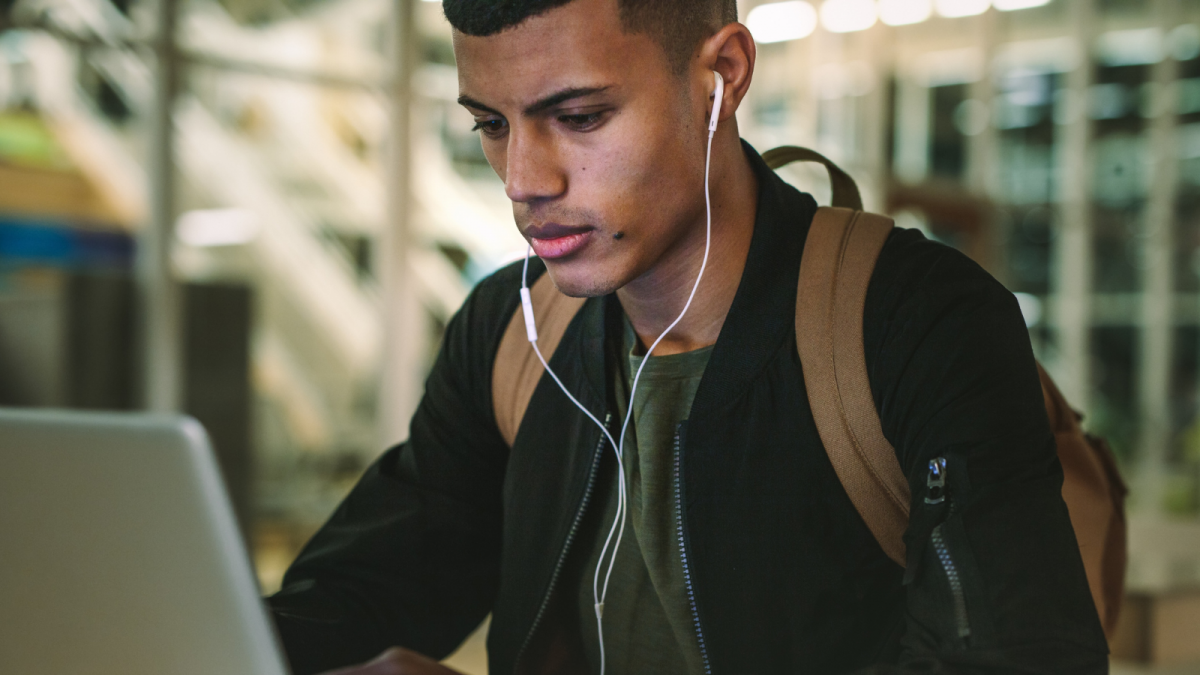 Student searching for work and grants on a computer.