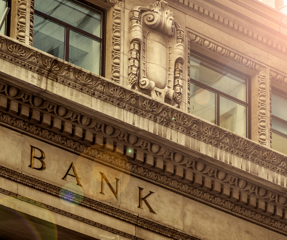 Image of front of old-style bank with lens flare